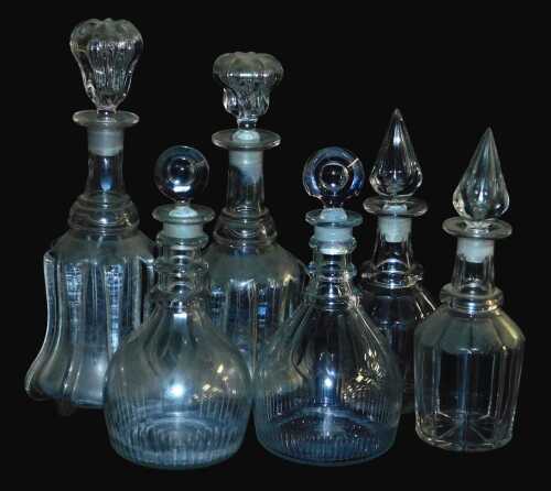 A near pair of George III triple ring neck decanters and stoppers, 27cm high, and two near pairs...