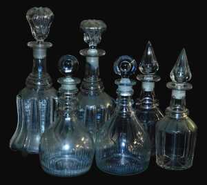 A near pair of George III triple ring neck decanters and stoppers, 27cm high, and two near pairs...