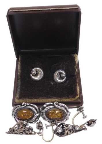 A pair of amber earrings, in a scrolling white metal frame, white metal stamped 925, and two...