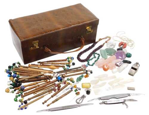 A faux skin box, containing quartz crystals, a whistle, pocket knives, bodkins, etc.