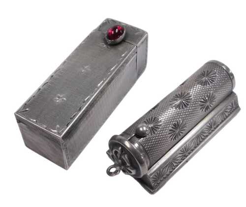 A Continental lipstick holder, with engine turned and engraved sunburst decoration, set on a...