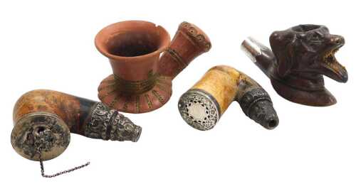 Four late 19thC pipe bowls, including a wooden pipe with bone teeth, carved as a dog's head,...