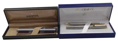 A Waterman ballpoint pen, and rollerball pen, latter presentation engraved, cased, together with...