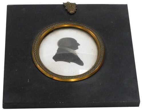 An early 19thC silhouette portrait of a gentleman, facing right, with a seal waxed card to the...