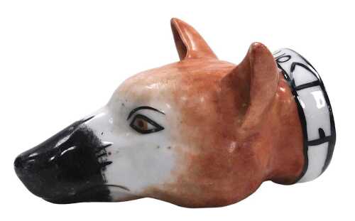 A 19thC Staffordshire porcelain stirrup cup modelled as a fox, the collar named "Tallio", 19.5cm...