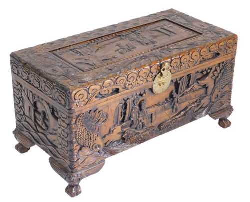 A mid 20thC Chinese camphor wood chest, profusely carved with figures, landscapes, and fish,...