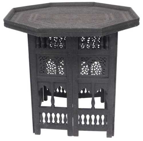 A late 19thC Indian tray top occasional table, the octagonal top carved with floral motifs,...