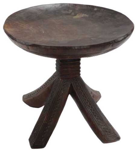 A Nigerian Igbo tribal stool, the domed circular top raised on a five collared column, over four...