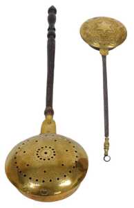 A 19thC pierced brass warming pan, with a turned wooden handle, 111cm long, and a smaller...