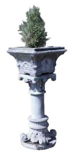 A reconstituted stone garden planter on a stand, the planter of square form, decorated on the...