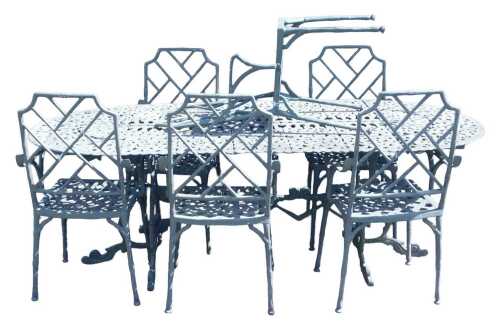 A green painted cast iron garden dining set, comprising an oval topped table, 69cm high x 204cm...