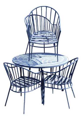 A cast iron garden dining set, comprising a circular table, with a ceramic set top in a...