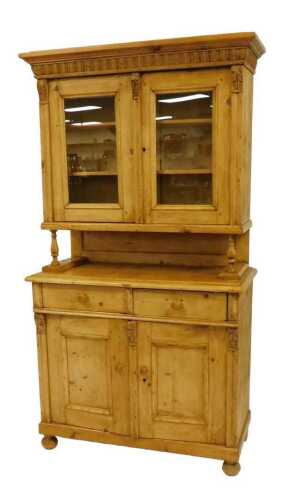 A 19thC pine dresser, the outswept pediment over a pair of glazed doors enclosing two shelves,...