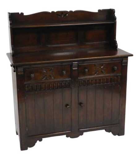 An Ercol style oak Welsh dresser, with a galleried back supporting a single shelf, above a base...