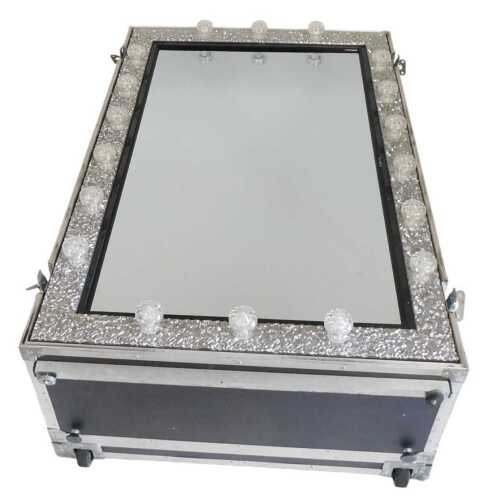 A wedding attire film recording mirror, with a rectangular mirrored plate with repeating lights...