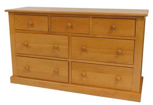A pine chest, of three short over four medium drawers, raised on a plinth, 78cm high, 134cm wide,...