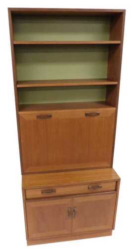 A G-Plan teak lounge unit, the top with a bookcase of two shelves, over a drop down drinks...