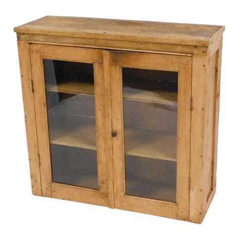 A Victorian pine cabinet, with a pair of glazed doors, 86cm high, 89cm wide, 31.5cm deep.
