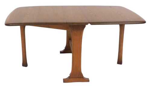An Ercol elm drop leaf occasional table, raised on end supports united by a stretcher, 46cm high,...