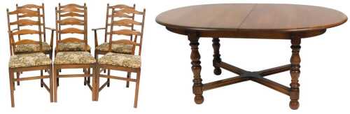 An Ercol elm draw leaf dining table, with an oval top, raised on turned legs united by an X...