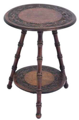 A Victorian oak gypsy table, the circular top with carved foliate decoration, raised on three...