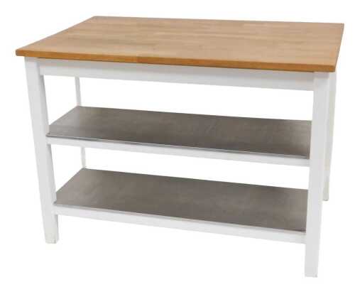 An oak topped kitchen island, with two metal topped shelves to one side, and a recess for bar...