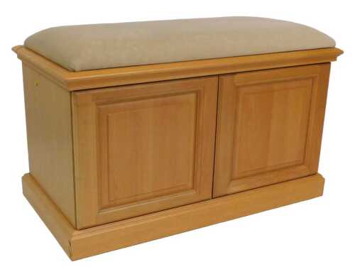 A light oak ottoman, the cantilever top upholstered in pale brown fabric, raised on a plinth,...