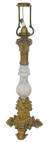 A late 19thC brass and white opaque glass table lamp, decorated with scrolls, flowers, etc., the...