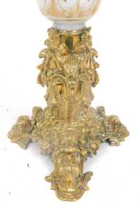A late 19thC brass and white opaque glass table lamp, decorated with scrolls, flowers, etc., the... - 2