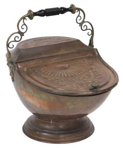 A Victorian copper coal scuttle, with a brass and ebonised handle, embossed with fruit and...