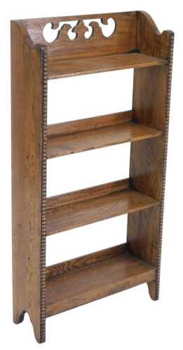An early 20thC oak open bookcase, with a carved galleried back, and four shelves, raised on...