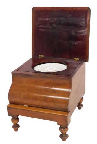 A Victorian mahogany commode, with an upholstered hinged lid opening to reveal a ceramic pot and...