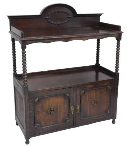 A Victorian oak buffet, with a galleried top, raised on bobbin turned supports, the under tier...