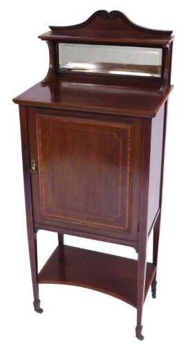 An Edwardian mahogany and satinwood crossbanded cabinet, with an arched pediment over a short...