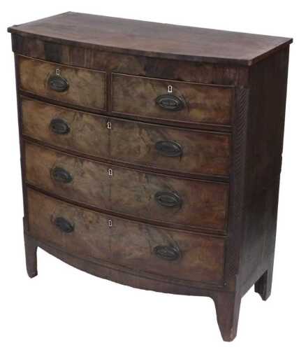 A late Georgian mahogany bow front chest, of two short over three long graduated drawers, with...