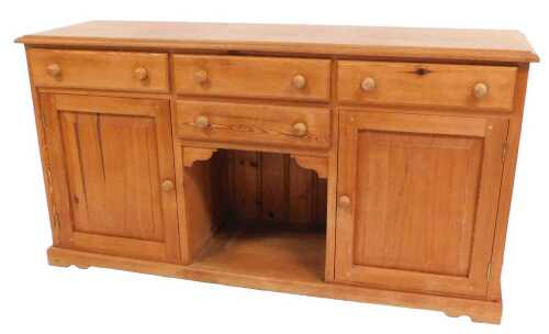 A pine dresser, with two central frieze drawers above a recess, flanked by two further drawers...
