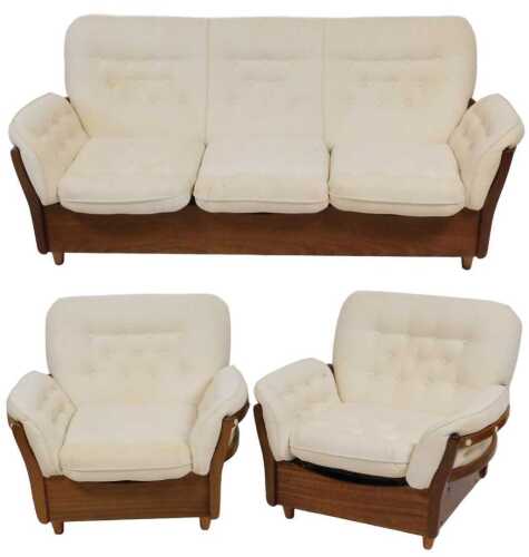 A mid century teak framed three seater sofa, with cream button back and loose cushion seats,...