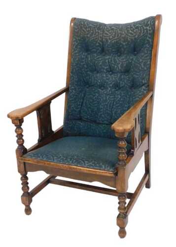 A Victorian mahogany armchair, upholstered in blue floral fabric, raised on turned legs, 62cm wide.