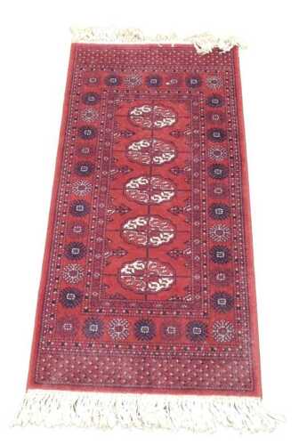 A Super Kashan red ground rug, with four central medallions, within repeating floral borders,...