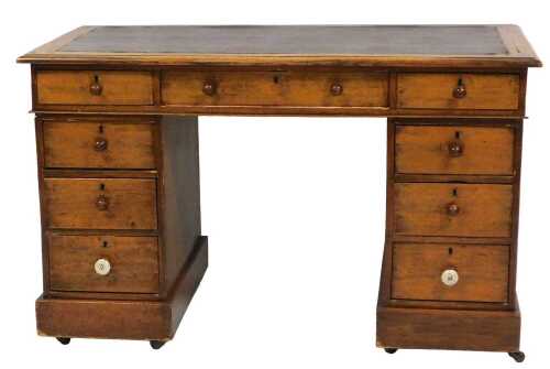 A Victorian oak twin pedestal desk, with one long flanked by two short frieze drawers, over two...