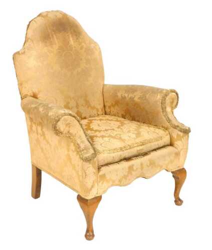 An early Georgian style upholstered scroll armchair, with cabriole legs, having distressed gold...