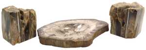 An ashtray formed from petrified wood, 33cm wide, and a pair of bookends, each approx 15cm high,...