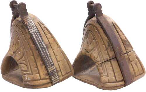A pair of 19thC Chilean carved wooden huaso stirrups, each with iron mounts, decorated with a...