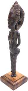 An African tribal Baule fertility figure, on a later hardwood stand, 29cm high overall. - 2