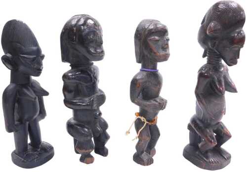 An African Baule fertility figure, on a rectangular base, 31cm high, and three further tribal...