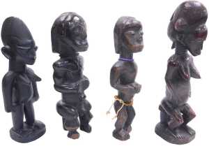 An African Baule fertility figure, on a rectangular base, 31cm high, and three further tribal...
