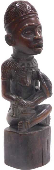 An African Yombe Congolese maternity figure, raised on a tapering base, 33cm high.
