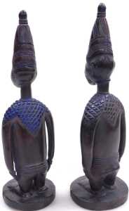 A pair of African Yoruba fertility figures, each with a tapering hat, and circular base,... - 2