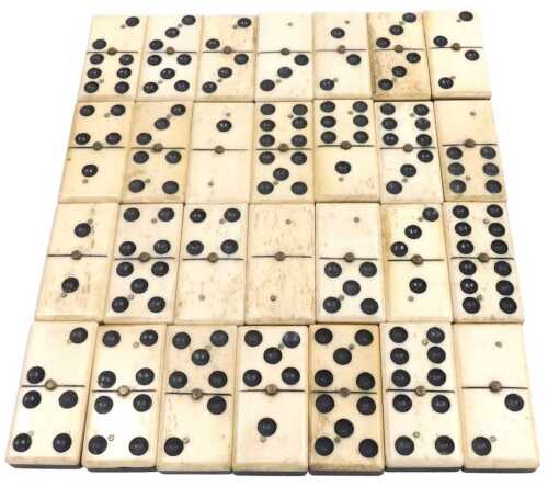 A set of 19thC bone and ebony dominoes, six spot, boxed.