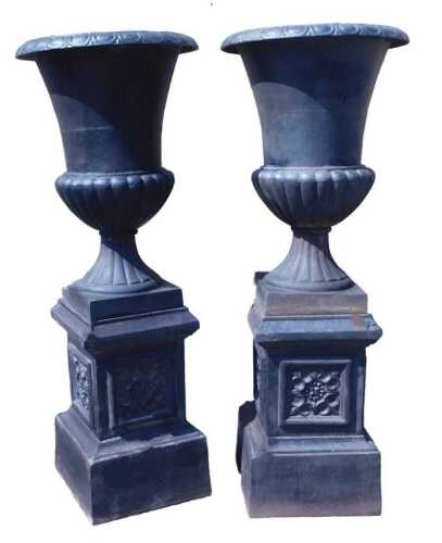 A pair of Victorian black painted cast iron garden urns on stands, the urns of campana form, on...